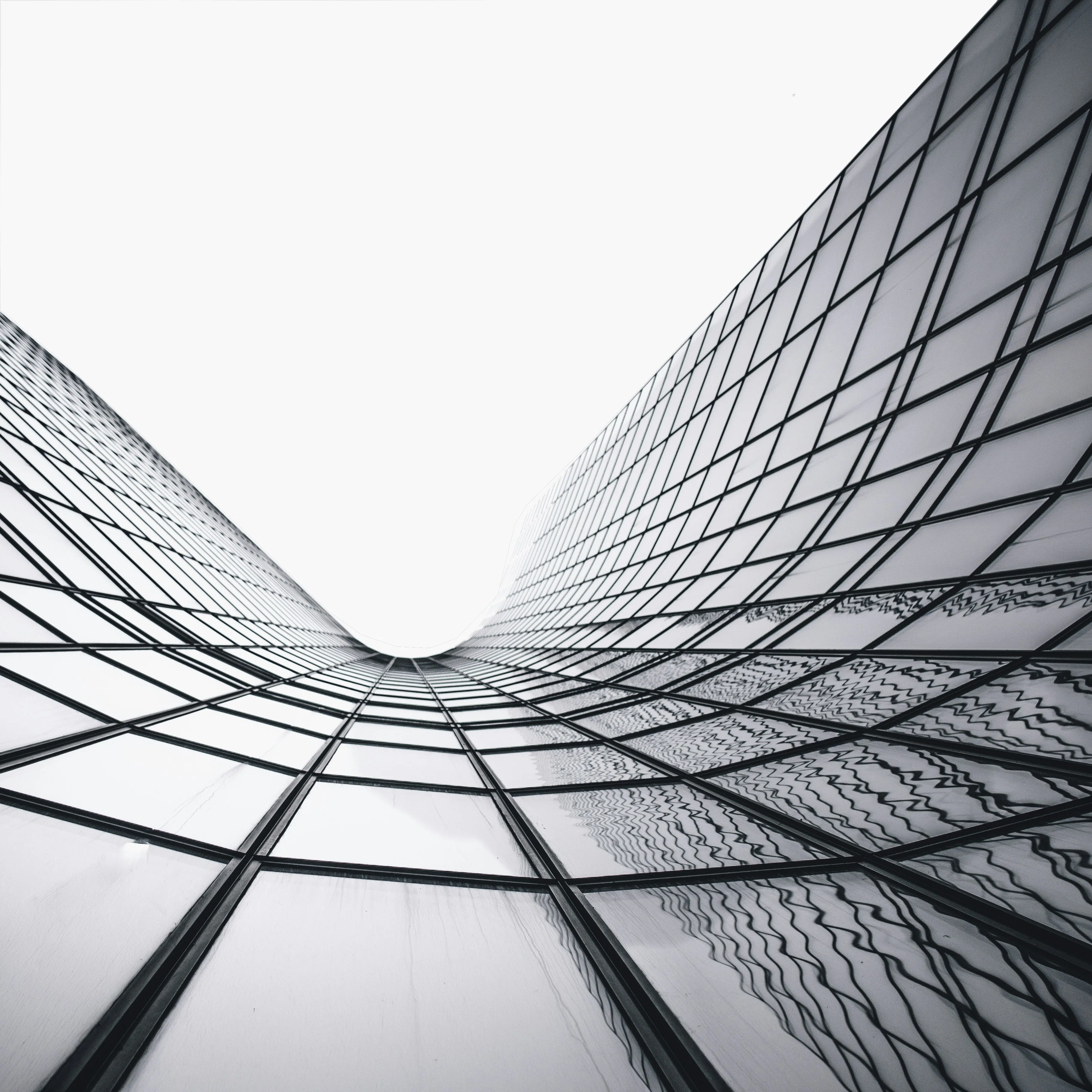 Glass office towers viewed from below in a monochrome architectural composition